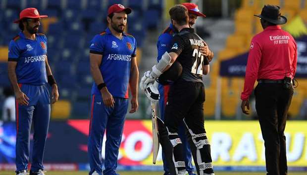 Afghanistan's captain Mohammad Nabi (C) greets his New Zealand's counterpart Kane Williamson.