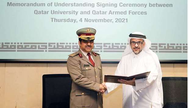 QU's Dr. Omar Al Ansari and Eng. Abdul Aziz Al-Dosari from the Qatar Armed Forces at the signing ceremony