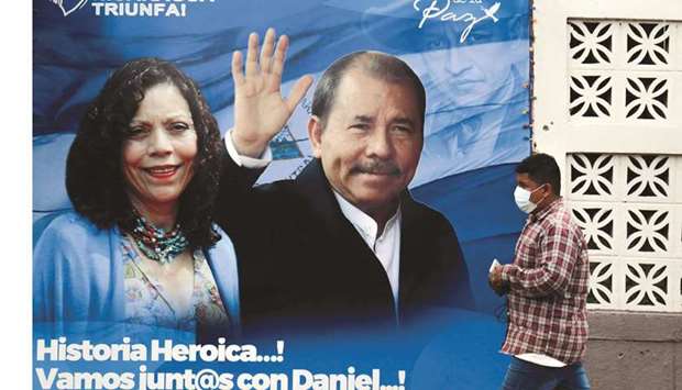 A man walks by a banner depicting Nicaraguan President Daniel Ortega and his spouse Vice President Rosario Murillo ahead of the presidential elections in Managua. (Reuters)