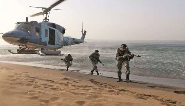 Members of the Iranian Army take part in a military exercise dubbed u2018Zulfiqar 1400u2019, in the coastal area of the Gulf of Oman, in this picture obtained yesterday.