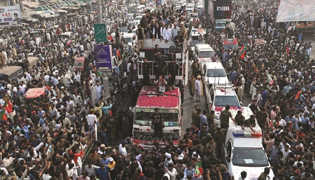 Pakistanu2019s former prime minister Imran Khan (centre on truck) leads an anti-government march in Muridke district, about 29km from Lahore, towards the federal capital Islamabad, demanding early elections. (AFP)