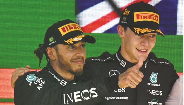Mercedesu2019 British driver Lewis Hamilton (left) and teammate Mercedesu2019 George Russell, also of Great Britain, celebrate on the podium of the Brazilian Grand Prix, at the Autodromo Jose Carlos Pace racetrack, also known as Interlagos in Sao Paulo, Brazil, on Sunday. (AFP)