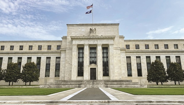 The Federal Reserve building in Washington, DC. Economists largely stuck to their forecasts that the Fed will raise interest rates to 5% by March and hold them there for most of 2023, even after inflation slowed last month by more than forecast.