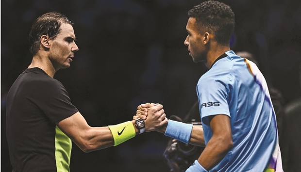 Spainu2019s Rafael Nadal (left) and Canadau2019s Felix Auger-Aliassime shake hands after the latter won their round-robin match at the ATP Finals in Turin. (AFP)