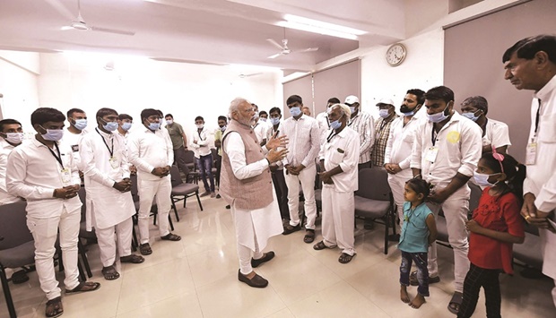 Prime Minister Narendra Modi meets with family members of the victims who lost their lives in the bridge that collapsed over river Machchhu, at Morbi Hospital yesterday. (AFP)