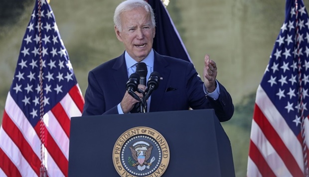 President Joe Biden speaks with dignitaries and employees (AFP)