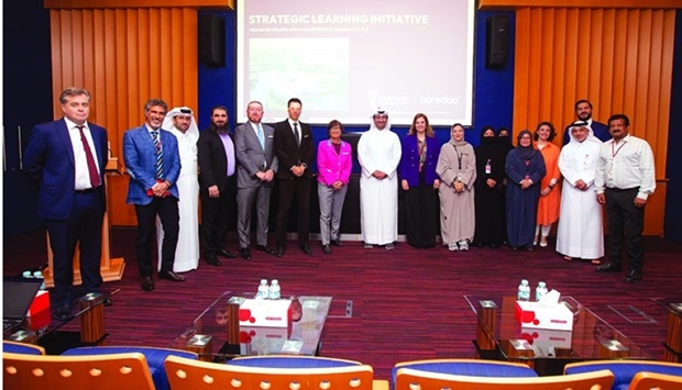 Officials from Ooredoo Qatar and HBKU's College of Law.