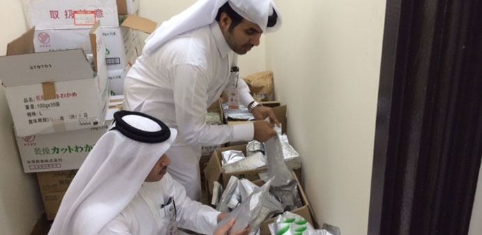 Municipality inspectors checking the dates on the packages. 