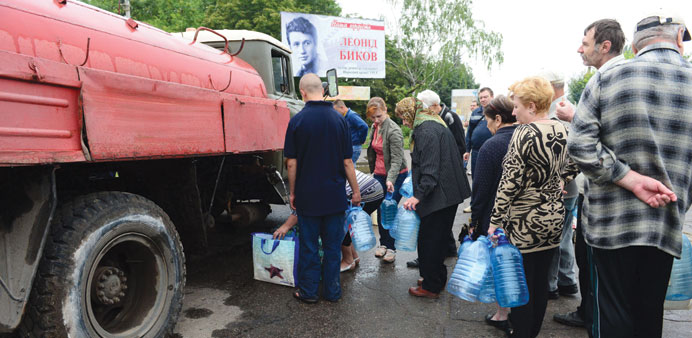 Residents queue for water in Kramatorsk, some 25km south of Sloviansk. Parts of the city have been without running water for two months.