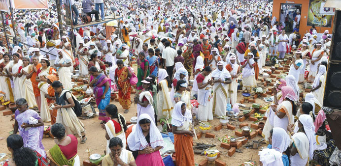Hindu women pray as they prepare rice porridge around the Attukal Bhagavathi temple during the Pongala Festival in Thiruvananthapuram yesterday.