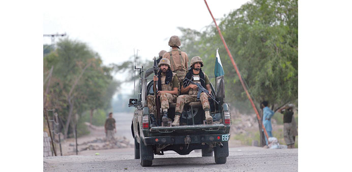 Pakistani troops patrolling near the site of an attack by militants on a security convoy in the village of Ghundai in Khyber tribal district yesterday