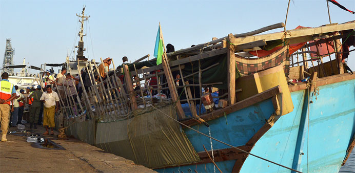 People arrive aboard a boat at the port of Djibouti after crossing the Gulf of Aden to flee Yemen