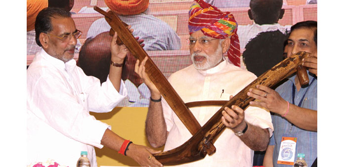 Prime Minister Narendra Modi is given a traditional plough by farmers representatives during the launch of DD Kisan, Doordarshanu2019s channel dedicated e