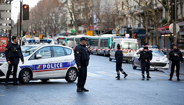 French police secure the area after a man was shot dead at a police station in the 18th district in Paris, France January 7, 2016.