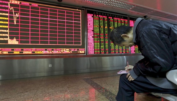 An investor takes notes of stock information in front of an electronic board at a brokerage house in Beijing. After one of the wildest weeks in recent memory for the most-volatile major stock market on the planet, even battle-hardened individual investors in China say they are getting fed up.