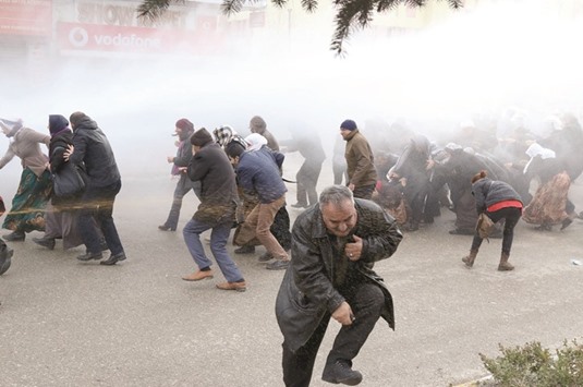 Riot police spray tear gas and water cannons at pro-Kurd demonstrators during a protest yesterday in the Kurd-dominated town of Van.