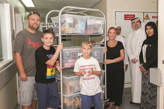 Finn Froud and family delivering packages of toys for child cancer patients at the Hamad General Hospital.