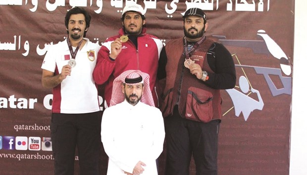 Rashid Hamad al-Athba (C), Masoud Ali al-Athba (L) and Hamad Ali al-Marri pose on the podium of double trap at the Losail Shooting Complex yesterday.