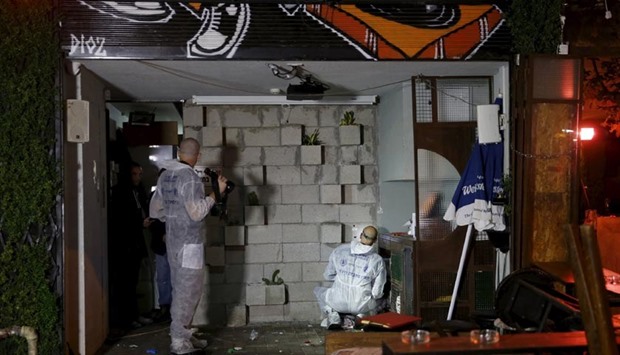 Israeli forensic policemen work at the scene of a shooting incident in Tel Aviv on Friday.