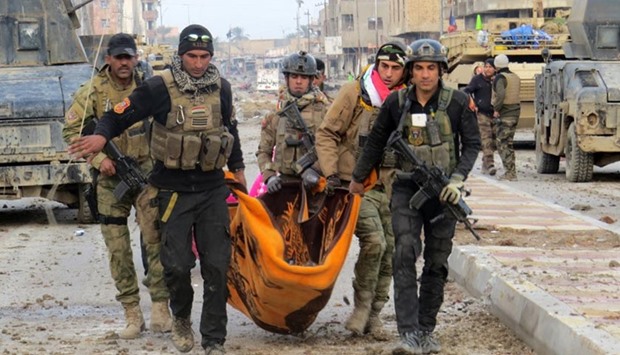 Iraqi government forces and members of Iraq's elite counter-terrorism service carry the body of a comrade during battles with Islamic State jihadists in Ramadi on Friday.