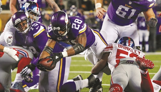 Minnesota Vikings running back Adrian Peterson (No 28) reaches across the goal line for a touchdown against the New York Giants in the third quarter NFL game at TCF Bank Stadium. PICTURE: USA TODAY Sports
