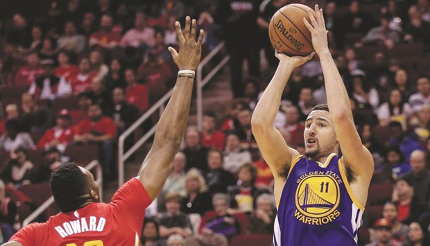 Klay Thompson (No 11) of the Golden State Warriors shoots over the outstretched arm of Dwight Howard of the Houston Rockets in the second half at Toyota Center in Houston, Texas. (Getty Images/AFP)