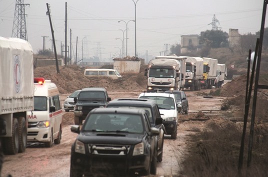 Aid vehicles drive in Syriau2019s Idlib province as they head to the government-controlled towns of Fuaa and Kafraya to deliver aid yesterday.