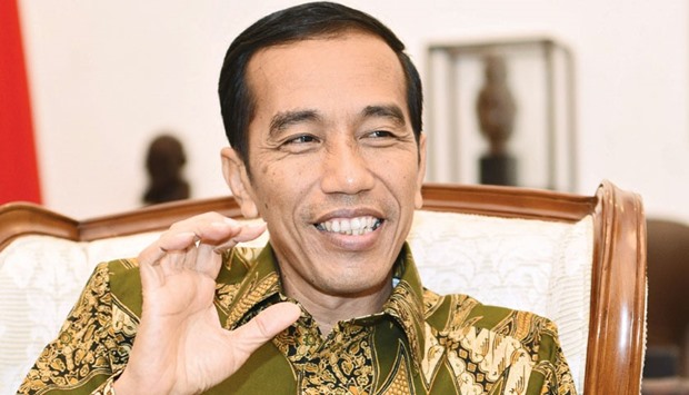 Widodo gestures as he speaks during an interview in his office at Istana Merdeka, the presidentu2019s official residence, in Jakarta (file). Indonesiau2019s ambition to rival Malaysia as a regional hub for finance catering to Muslims is being hindered by a lack of progress in scrapping double taxation on sukuk and a delay in creating an Islamic megabank.