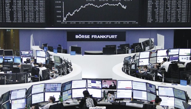 Traders work at the Frankfurt Stock Exchange. The bourse yesterday rose 1.6%.
