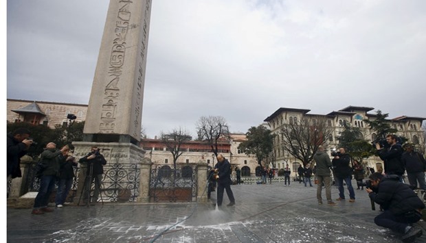 A municipality worker cleans the site of Tuesday's suicide bomb attack at Sultanahmet square in Istanbul, Turkey