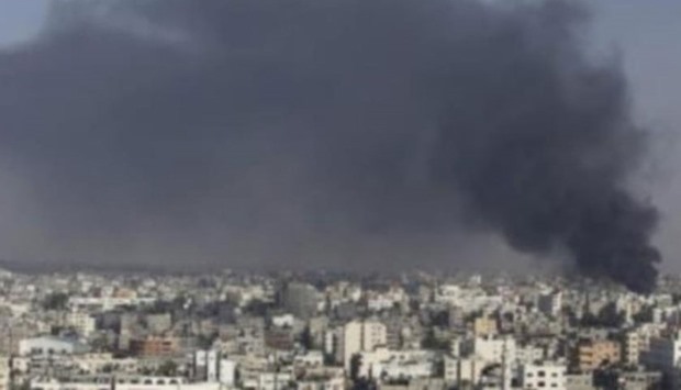 Smoke rises following an air strike in the east of Gaza City