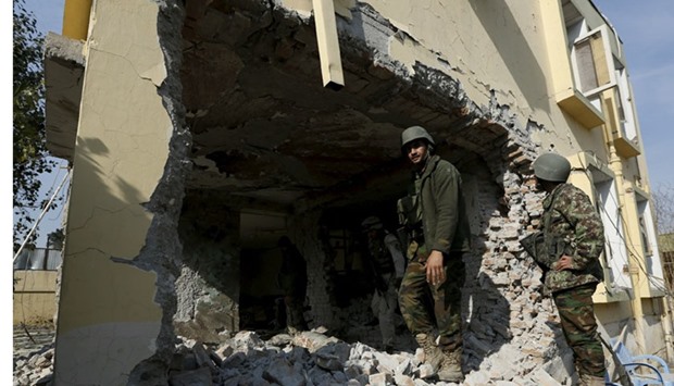 Afghan National Army (ANA) soldiers inspect a damaged building after a blast near the Pakistani consulate in Jalalabad, Afghanistan. Reuters.