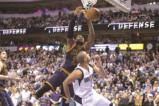Cleveland Cavaliers forward LeBron James (23) dunks the ball over Dallas Mavericks guard Devin Harris (34) during the second half of their game on Tuesday. The Cavaliers defeat the Mavericks 110-107 in overtime. Picture: Jerome Miron-USA TODAY Sports