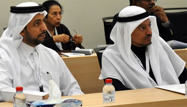 HE the Minister of Labour and Social Affairs Dr Abdullah Saleh Mubarak al-Khulaifi (right) and QU pr