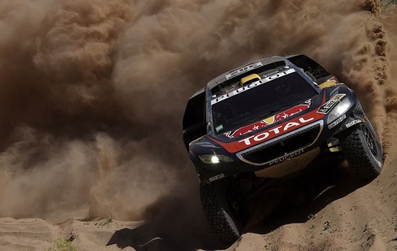Peugeotu2019s driver Stephane Peterhansel and co-driver Jean Paul Cottret, both from France, compete during the 2016 Dakar Rally yesterday. (AFP)