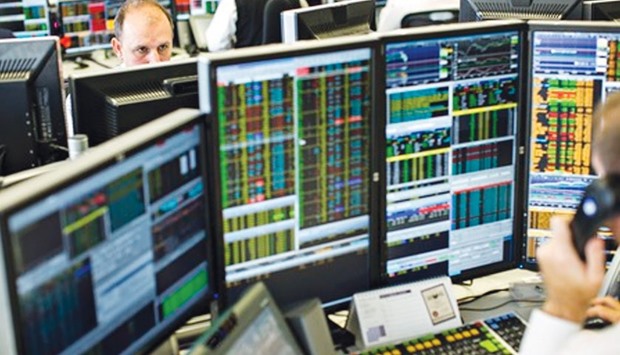 Traders monitor share prices at the London Stock Exchange. The bourse yesterday gained 0.5%.