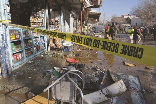 Pakistani security officials examine the site of a bomb blast near a polio vaccination centre in Quetta yesterday.