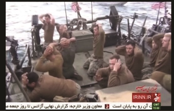 US sailors are pictured on a boat with their hands on their heads at an unknown location in this still image taken from video. Iran released 10 US sailors yesterday after holding them overnight, bringing a swift end to an incident that had rattled nerves days ahead of the expected implementation of a landmark nuclear accord between Tehran and world powers.