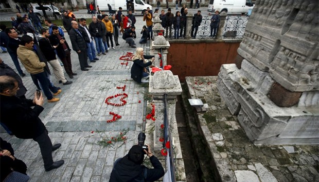 A woman places flowers at the site of Tuesday's suicide bomb attack at Sultanahmet square in Istanbul, Turkey. Reuters