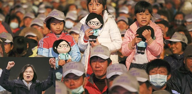 Girls hold dolls featuring Taiwanu2019s Democratic Progressive Party chairperson and presidential candidate Tsai Ing-wen (inset) during a campaigning rally in Hsinchu ,Taiwan.