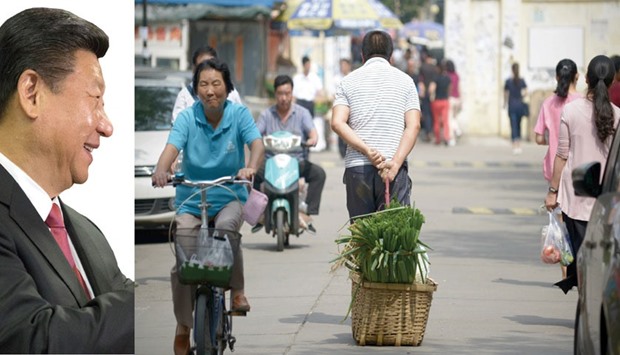 The picture taken on September 8, 2015 shows a man pulling a basket of leeks as he walks along a road near an open market in Beijing. Thereu2019s been no real progress in chipping away at the debt burden, supercharged by spending on infrastructure and housing, that delivered average economic growth of 10% over the past 30 years. Government, corporate, and household borrowing totalled $28tn as of mid-2014, or about 282% of the countryu2019s GDP at the time, according to McKinsey & Co.