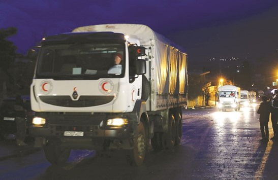 An aid convoy from the Syrian Arab Red Crescent enters the besieged town of Madaya.