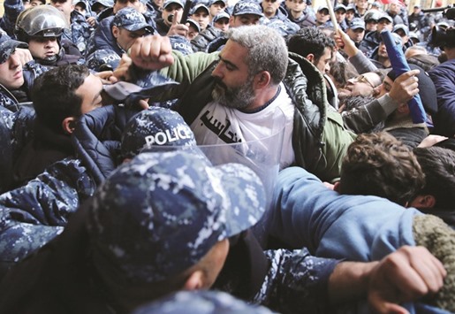Lebanese civil society activists scuffle with riot police as they try to storm the Lebanese Ministry of Environment during an anti-government rally in Beirut to protest against government policies to solve the waste crisis.