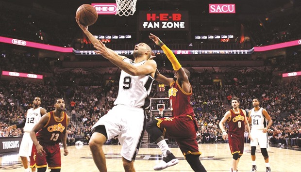 San Antonio Spurs point guard Tony Parker shoots the ball past Cleveland Cavaliersu2019 Kyrie Irving during the first half of the NBA game at AT&T Center. (USA TODAY Sports)