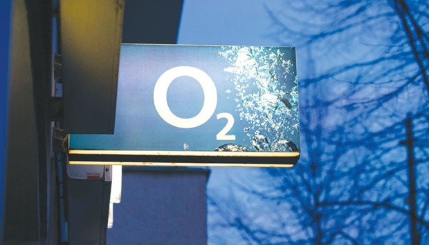 The O2 logo is seen on a illuminated sign outside a mobile phone store operated by Telefonica Deutschland Holding in Berlin. The European Commission said yesterday that it can ensure consistency in the application of merger rules to probe CK Hutchison Holdingsu2019 proposed acquisition of Telefonicau2019s 02 unit in the UK.