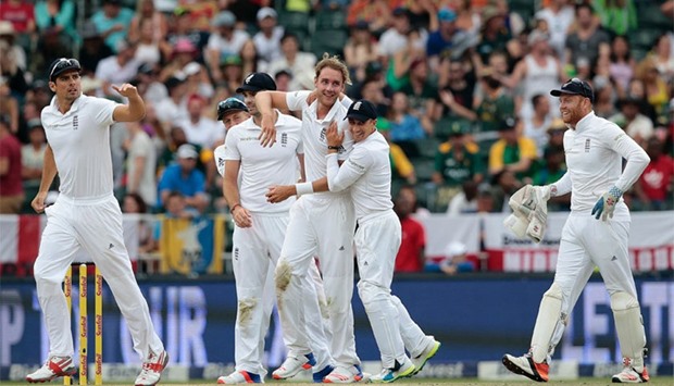 England's bowler Stuart Broad(C) celebrates the dismissal of South African batsman Faf du Plessis (not in picture) during day 3 of the third Test match between England and South Africa at Wanderers stadium in Johannesburg. AFP