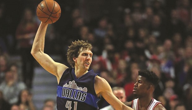 Top: Dirk Nowitzki (L) of the Dallas Mavericks takes a pass next to Jimmy Butler of the Chicago Bulls at the United Center in Chicago on Friday.