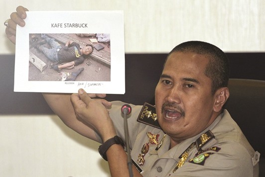 Jakarta Police medical division chief officer Musyafak shows a photo of suspected dead militant identified as Afif, alias Sunakin, at Jakarta police headquarters yesterday in this photo taken by Antara Foto.