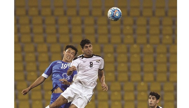 Iraqu2019s Mohanad Abdulraheem Karrar (right) and Igor Sergeev of Uzbekistan vie for the ball during the AFC U-23 Championship yesterday. PICTURE: Mamdouh
