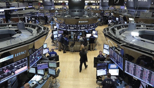 Traders work on the floor of the New York Stock Exchange on Friday. Global equities have lost more than $14tn, or 20%, since June, according to a Bloomberg report.